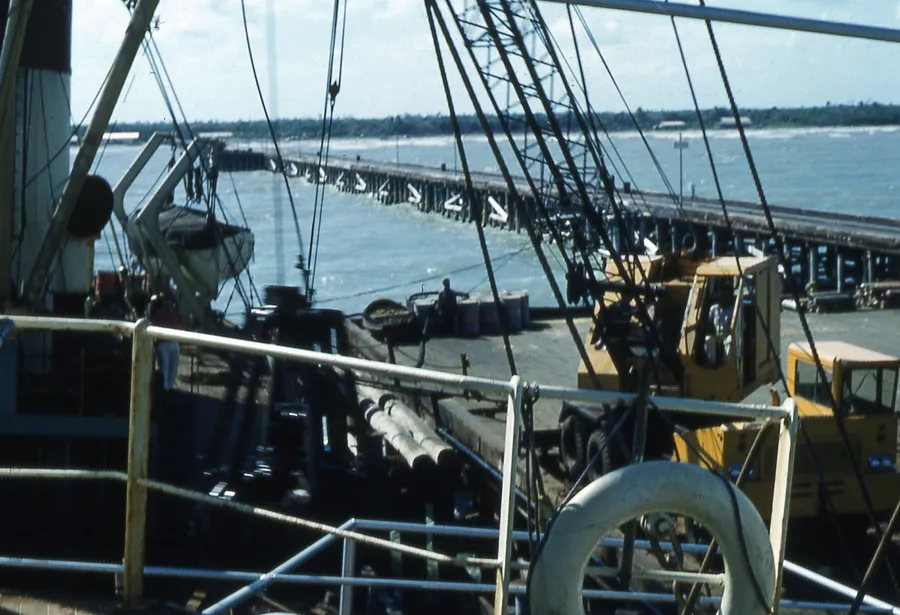 General cargo being worked on the deck of a ship at a quay