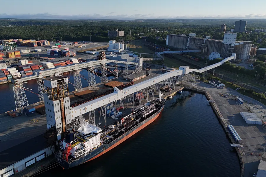 A bulk carrier alongside a grain elevator, loading